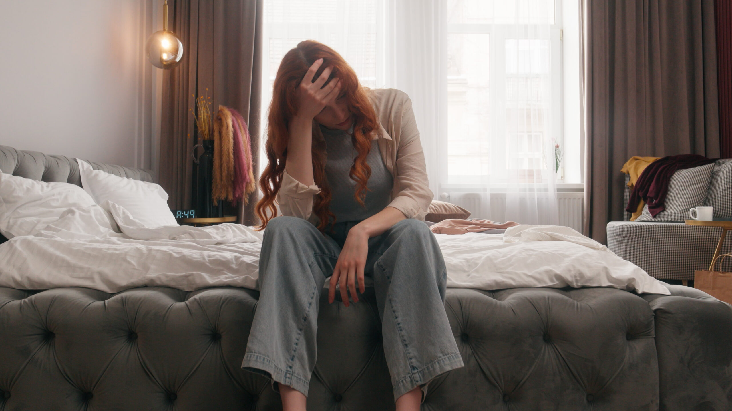 Exhausted sad upset Caucasian woman girl female homeowner lady housewife tired headache stress anxious frustrated mess in bedroom cleaning home chore problem trouble messy dirty housekeeping cleanup. High quality 4k footage